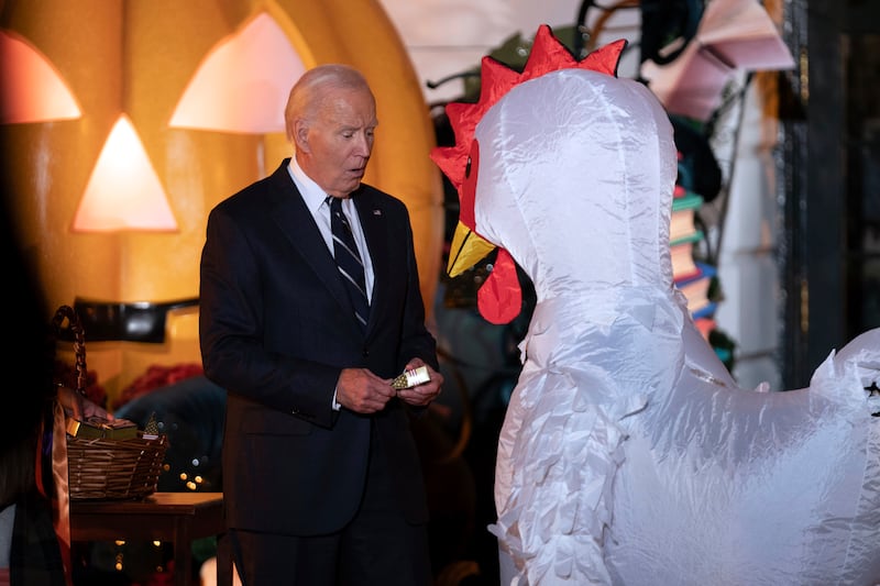 President Joe Biden gives treats to trick-or-treaters at the South Lawn of the White House on Halloween (Jose Luis Magana/AP)