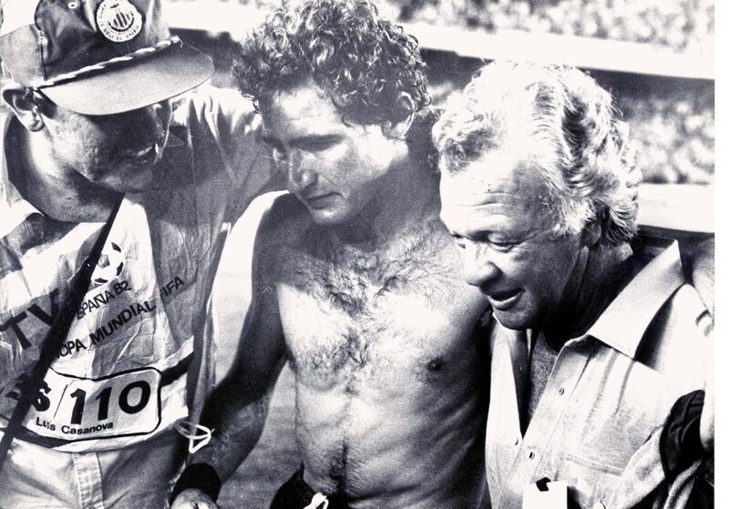 Exhausted Northern Ireland captain Martin O&#39;Neill (centre) is supported by manager Billy Bingham (right) after the shock 1-0 victory over hosts Spain at the 1982 World Cup. 