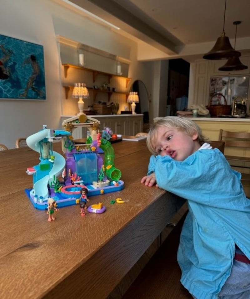 Louise Thompson’s son Leo with the Heartlake City Water Park toy from the Lego Group