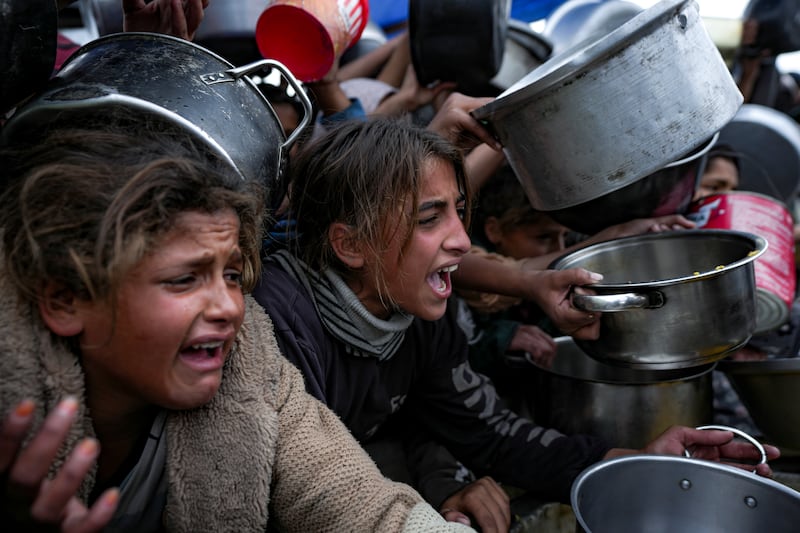 Palestinian girls at a food distribution centre in Khan Younis in Gaza on Friday (Abdel Kareem Hana/AP)