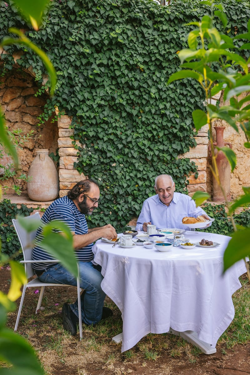 Fadi Kattan (L) eating breakfast with his father, Fuad