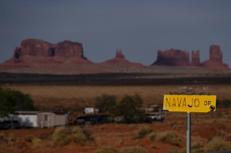 A sign marks Navajo Drive, as Sentinel Mesa stands in the distance (Carolyn Kaster/AP)