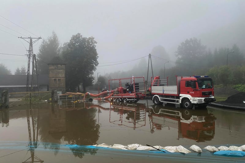 Firefighters pump water and mud from city streets and help clean the city of Glogow that was hit by a high flood wave in south-western Poland