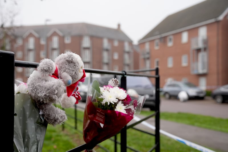 People placed flowers and other tributes near the apartment block