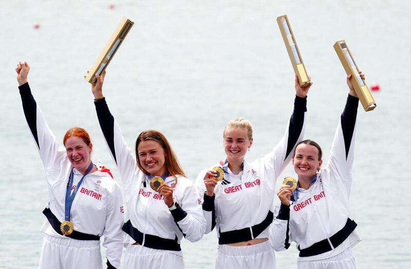 Great Britain’s Lauren Henry, Hannah Scott, Lola Anderson and Georgie Brayshaw celebrate with their gold medals following the Women’s Quadruple Sculls Final