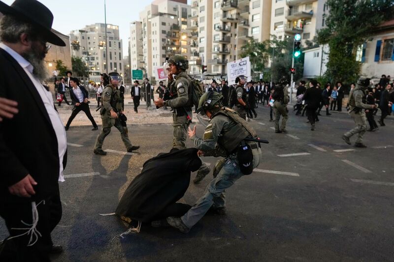 Ultra-Orthodox Jewish men clashed with police (Ohad Zwigenberg/AP)