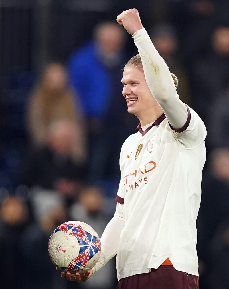 Erling Haaland celebrates with the match ball