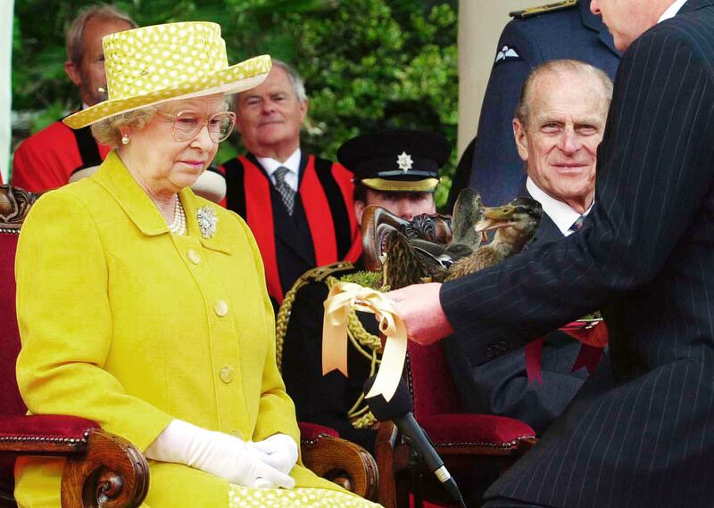 Elizabeth II is presented with two dead mallards on a silver platter in an act of homage by Steve Morgan, seigneur of the Parish of Trinity, on Jersey in 2001