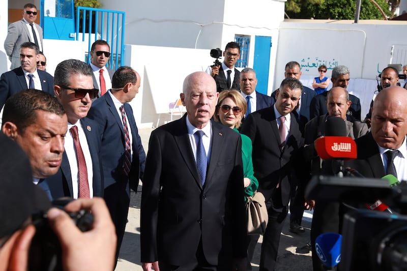 Tunisian president and candidate for re-election Kais Saied attended a polling station in the capital Tunis with his wife (Anis Mili/AP)