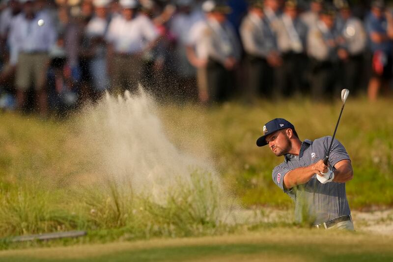 Bryson DeChambeau hits from the bunker on the 18th hole on his way to winning the US Open (Matt York/AP)
