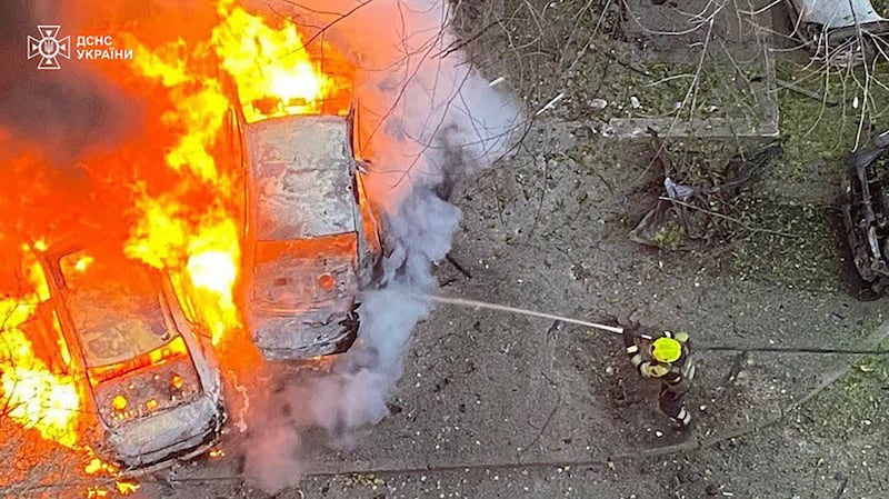 Emergency services personnel work to extinguish a blaze following a Russian rocket attack in Ukraine (Ukrainian Emergency Service via AP)