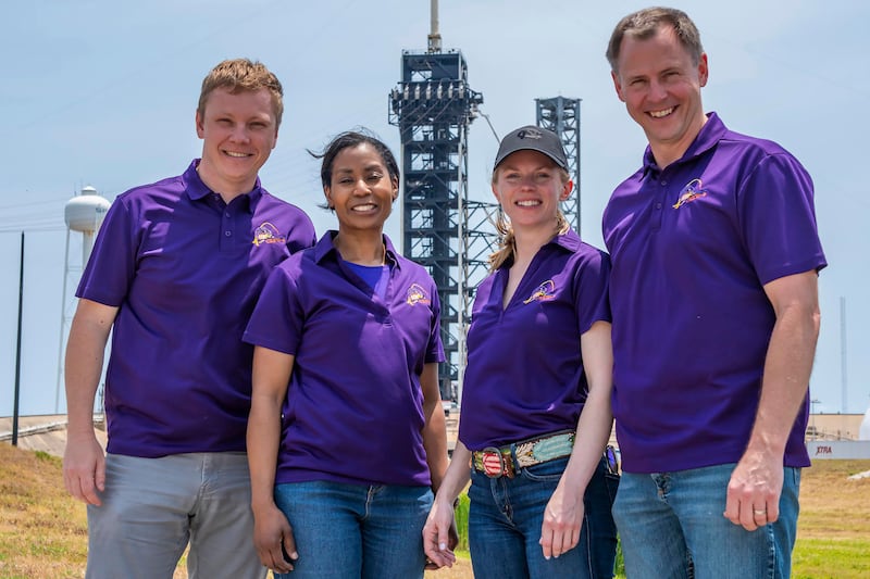 Left to right, Russian Aleksandr Gorbunov, and Nasa’s Stephanie Wilson, Zena Cardman and Nick Hague in front of the launch tower at Launch Complex 39A at the Kennedy Space Centre in Florida (SpaceX via AP)