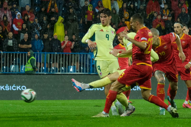 Kieffer Moore fires home Wales’ opening goal (Risto Bozovic/AP).