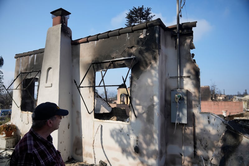 Joel Parkes, a teacher at Los Angeles Unified School District returns to his destroyed home in the aftermath of the Eaton Fire (AP/Damian Dovarganes)