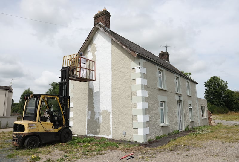 Painting a house Orange and White in Camlough ahead of Armagh’s All Ireland Final against Galway.
PICTURE COLM LENAGHAN