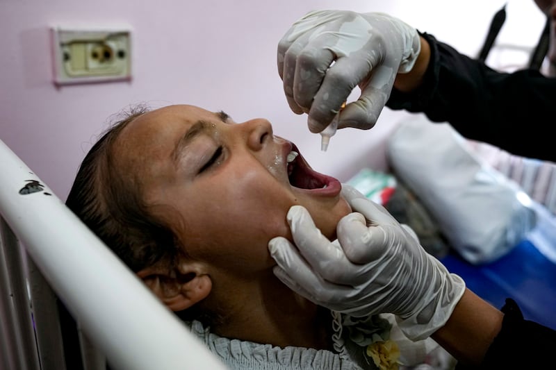 The vaccine is administered by oral drops (Abdel Kareem Hana/AP)