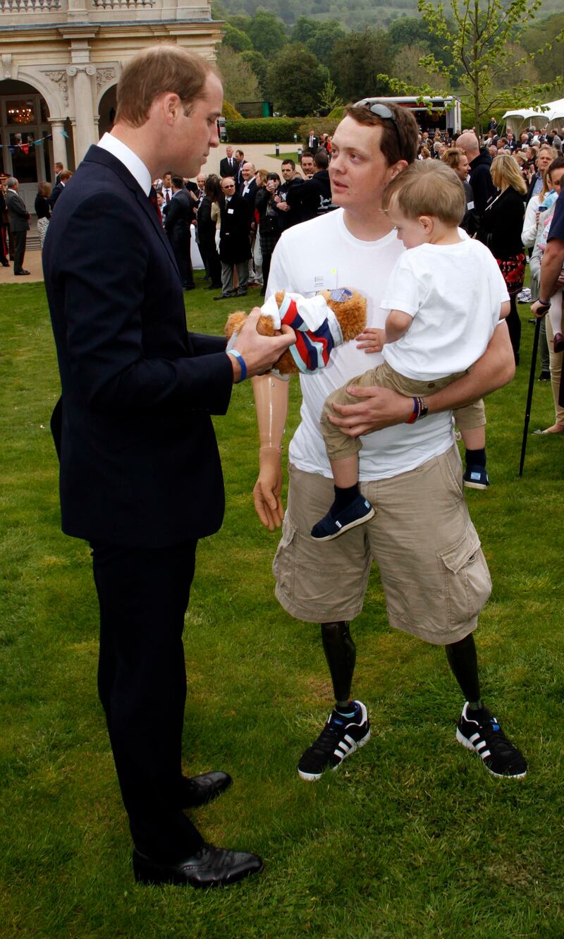 William meeting Josh Boggi and his son, Jenson, at Tedworth House in Wiltshire where he and Harry officially opened a Help for Heroes Recovery Centre in 2013