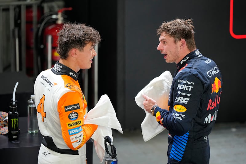 Max Verstappen in conversation with Lando Norris (Vincent Thian/AP)