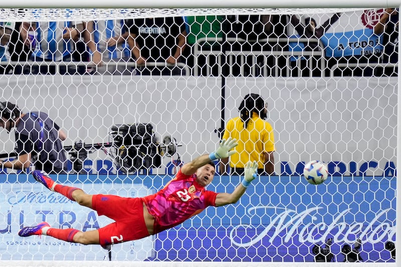 Argentina’s goalkeeper Emiliano Martinez stops a penalty shot by Ecuador’s Angel Mena (Kevin M Cox/AP)