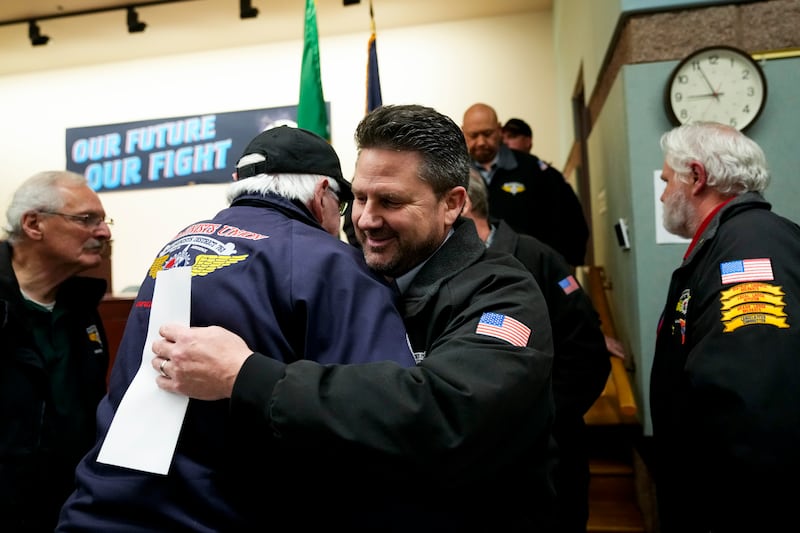 IAM District 751 president Jon Holden greets union members after announcing they voted to accept a new contract offer at their union hall in Seattle. (AP/Lindsey Wasson)