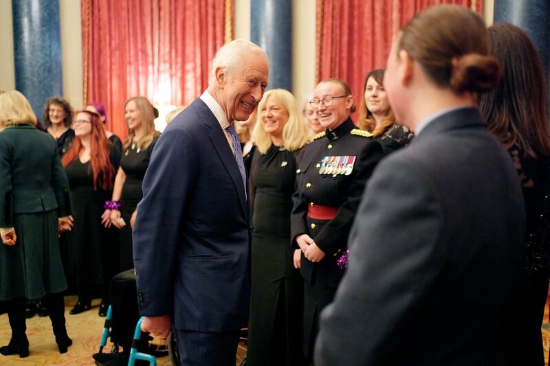 Charles chats to members of the Military Wives Choir after their performance at Buckingham Palace