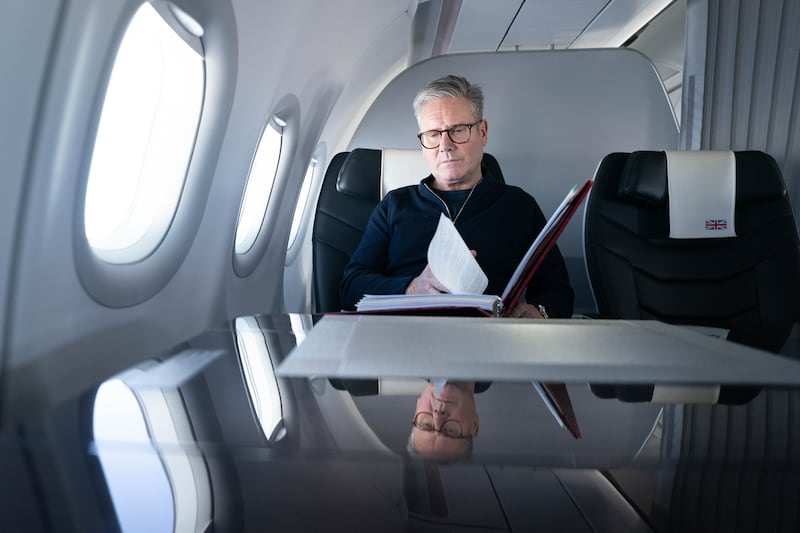 Sir Keir Starmer works on board a Government plane as he travels to Rio de Janeiro, Brazil to attend the G20 summit