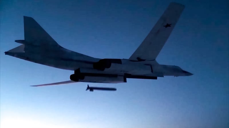 A Russian Tu-160 strategic bomber fires a cruise missile at test targets during a military drill in Russia (Russian Defence Ministry Press Service/AP)