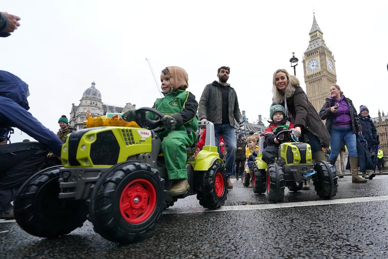 Children on toy tractors during a farmers protest in central London over the changes to inheritance tax