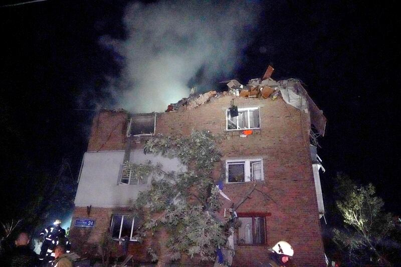 Firefighters put out a fire at an apartment building damaged in a Russian missile attack in Kharkiv (Andrii Marienko/AP)