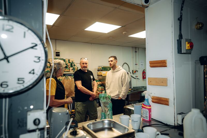 The football player, right, and his partner helped serve hot meals to more than 100 people during their visit