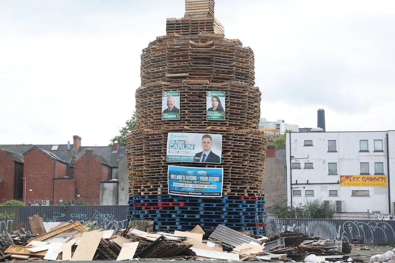 A bonfire in Belfast's Donegall Pass area, with Sinn Féin election posters and an Ireland's Future banner.