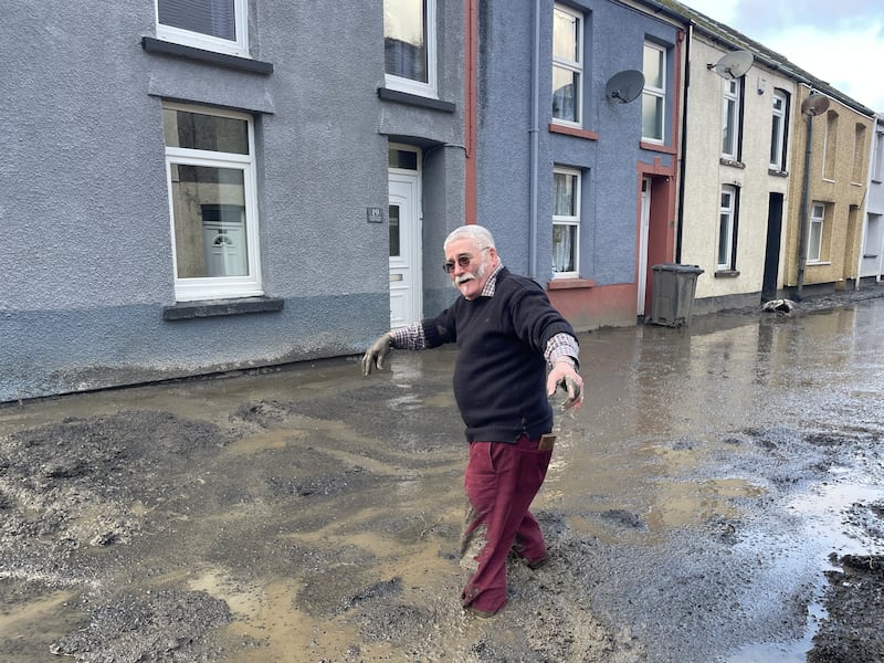 Rob Scholes, 75, walking through flood water in Cwmtillery