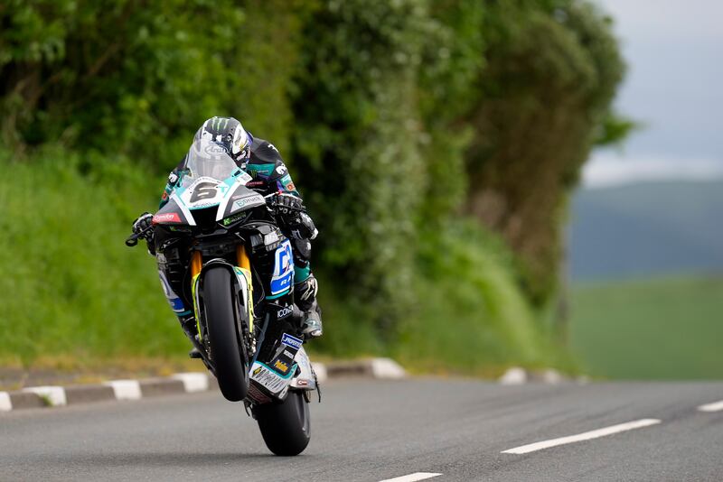 Michael Dunlop pulling a wheelie on the Mountain course in the Isle of Man TT 2024