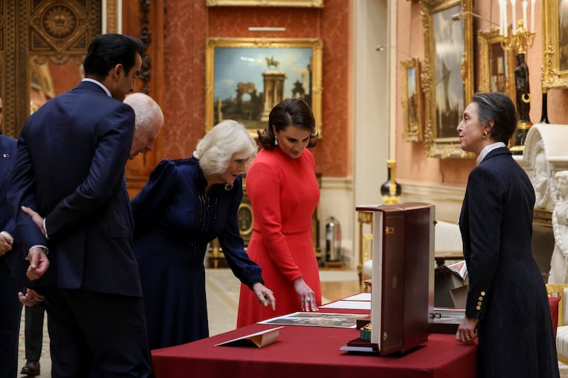 The King and Queen with the Emir of Qatar Sheikh Tamim bin Hamad Al Thani (left) and his wife Sheikha Jawaher (right) view a display of Qatari items from the Royal Collection at Buckingham Palace