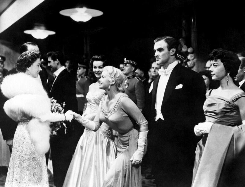 Queen Elizabeth II shakes hands with Hollywood actress Jayne Mansfield at the Royal Film Performance of Les Girls at the Odeon in Leicester Square in 1957