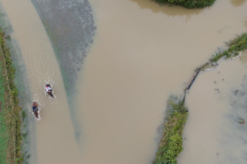 Horse riders make their way through floodwater in Walton in Warwickshire