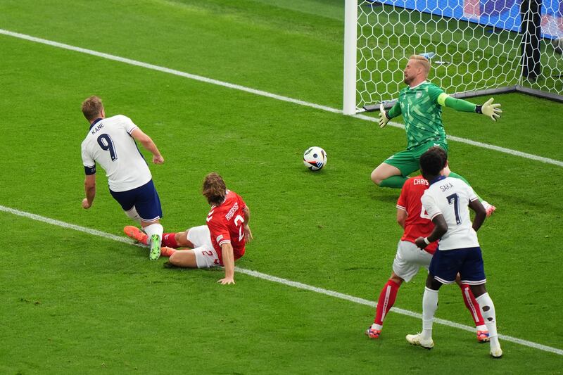 England’s Harry Kane opens the scoring against Denmark .