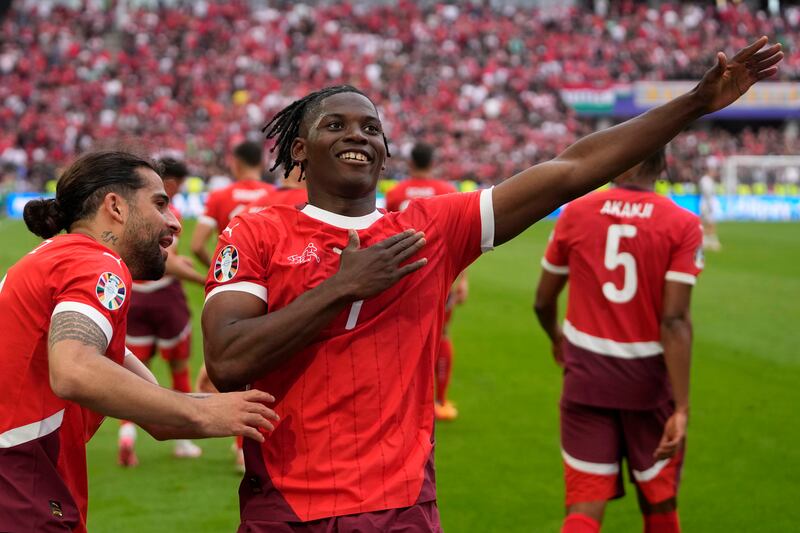 Breel Embolo celebrates after scoring Switzerland’s third goal against Hungary (Darko Vojinovic/AP)