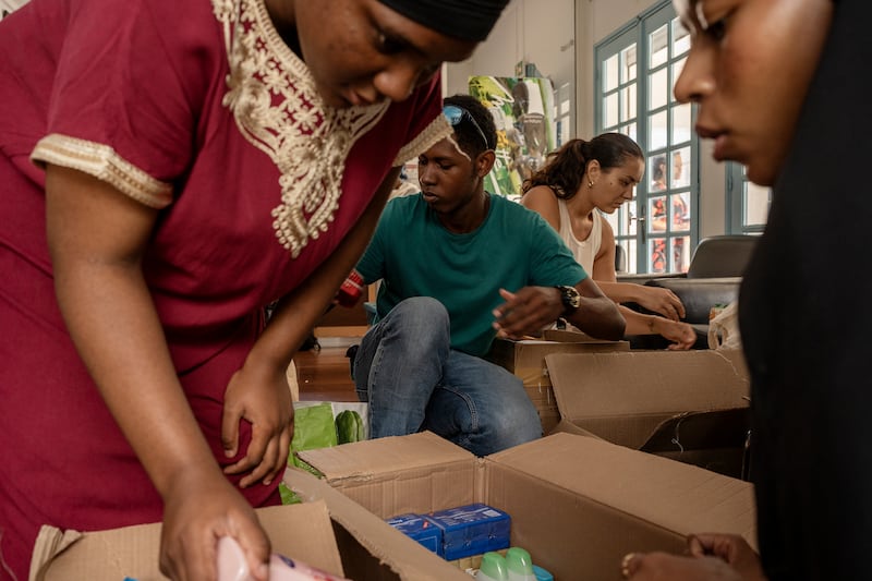 Volunteers sort through donations for victims of Cyclone Chido in Mayotte (Adrienne Surprenant/AP)