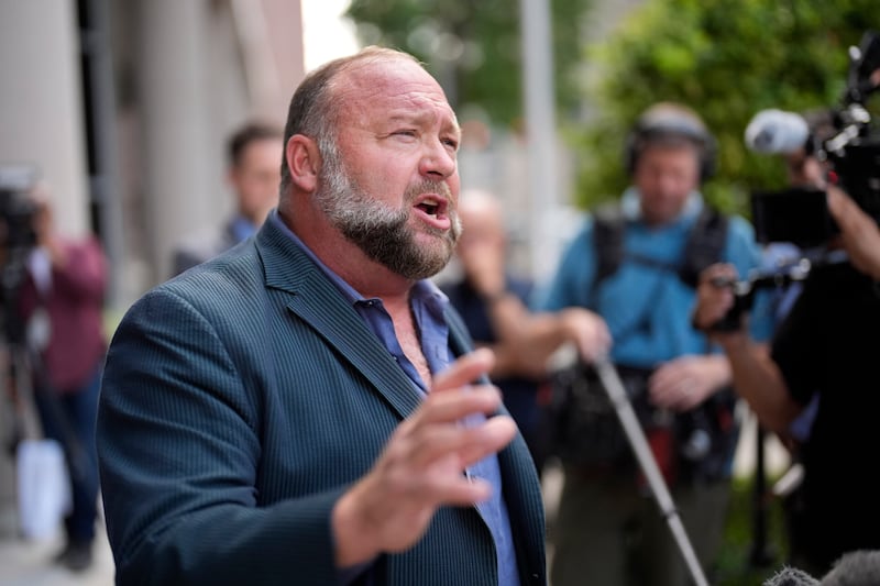 Right-wing conspiracy theorist Alex Jones speaks to the media after arriving at the federal courthouse for a hearing in front of a bankruptcy judge (AP/David J Phillip)