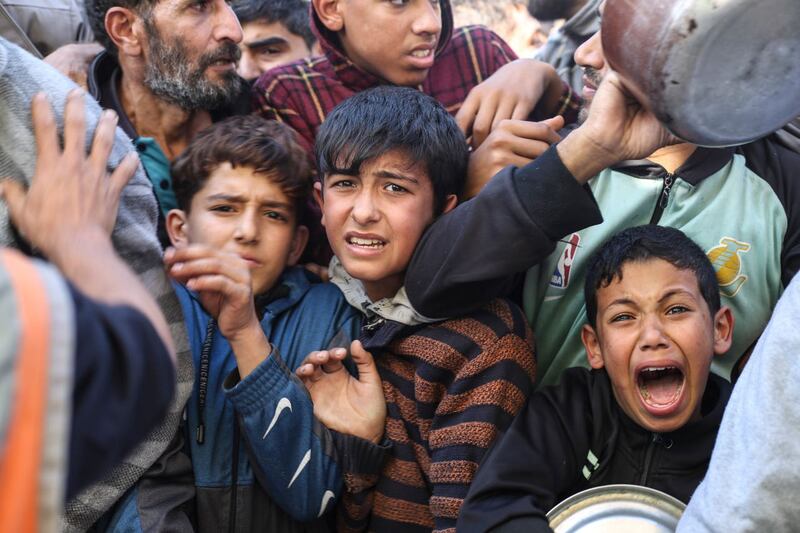 Children line up for food