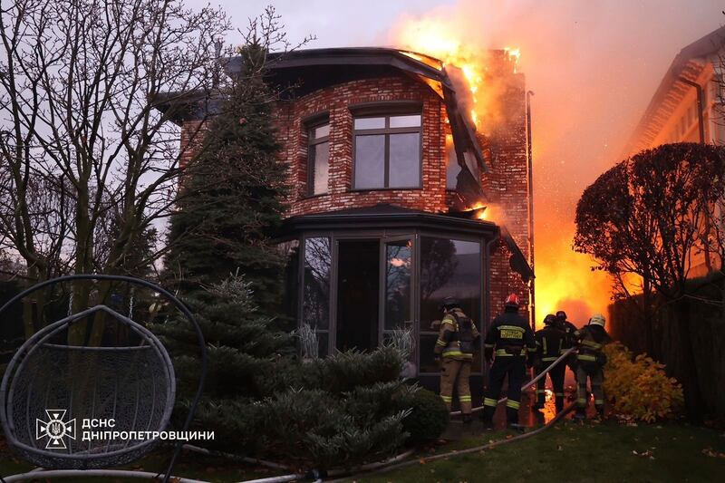 Firefighters tackle a blaze at a house damaged by a Russian strike on Dnipro, Ukraine (Ukrainian Emergency Service via AP)