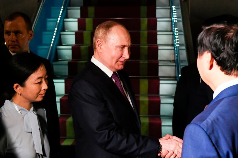 Russian President Vladimir Putin, second left, shakes hands with Vietnamese officials (Nikita Orlov, Sputnik, Kremlin Pool Photo via AP)