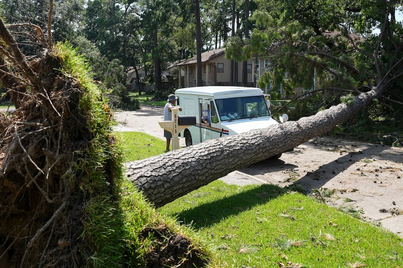 Downed trees caused issues for workers (Jon Shapley/Houston Chronicle/AP)