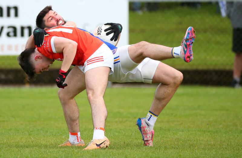 Maghery’s Steven Fox and Clann Eireann’s Emmett Magee   during Saturday’s  Championship game in Maghery.
PICTURE COLM LENAGHAN