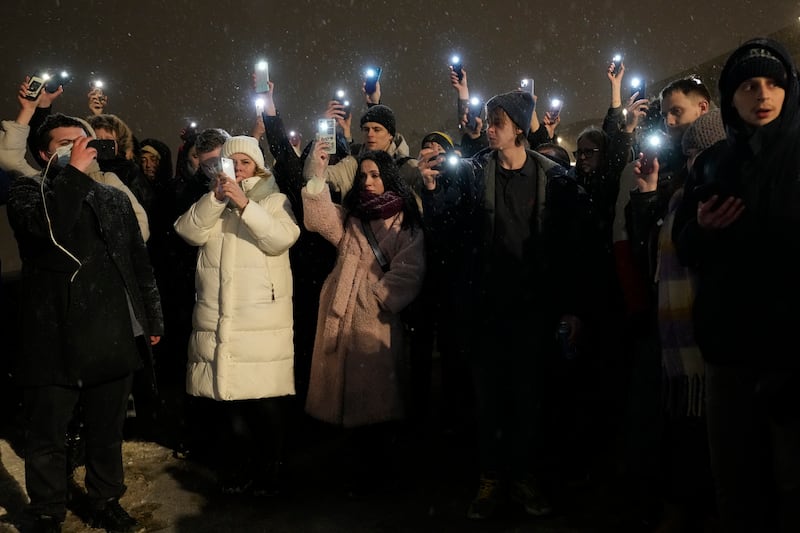 People hold up their mobile phones with lights paying their last respect to Alexei Navalny in St. Petersburg (AP Photo/Dmitri Lovetsky)