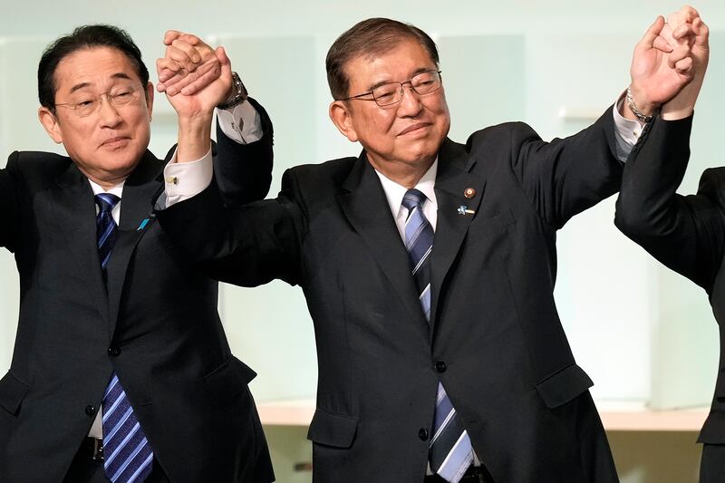 Shigeru Ishiba, right, with Japan’s Prime Minister Fumio Kishida, left, celebrates after being elected as new head of Japan’s ruling Liberal Democratic Party (Hiro Komae, Pool/AP)