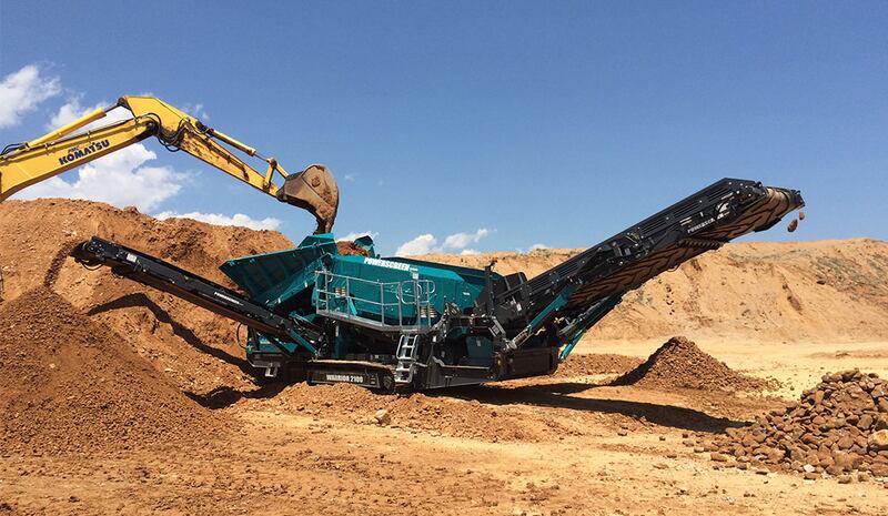 A powerscreen machine operating in a remote quarry.