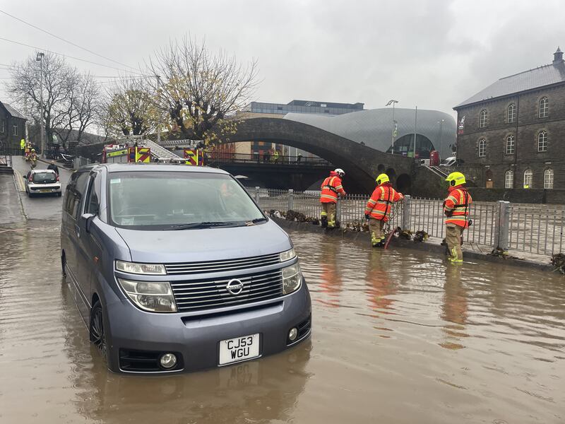 Firefighters pumping water from Sion Street by the River Taff, in Pontypridd