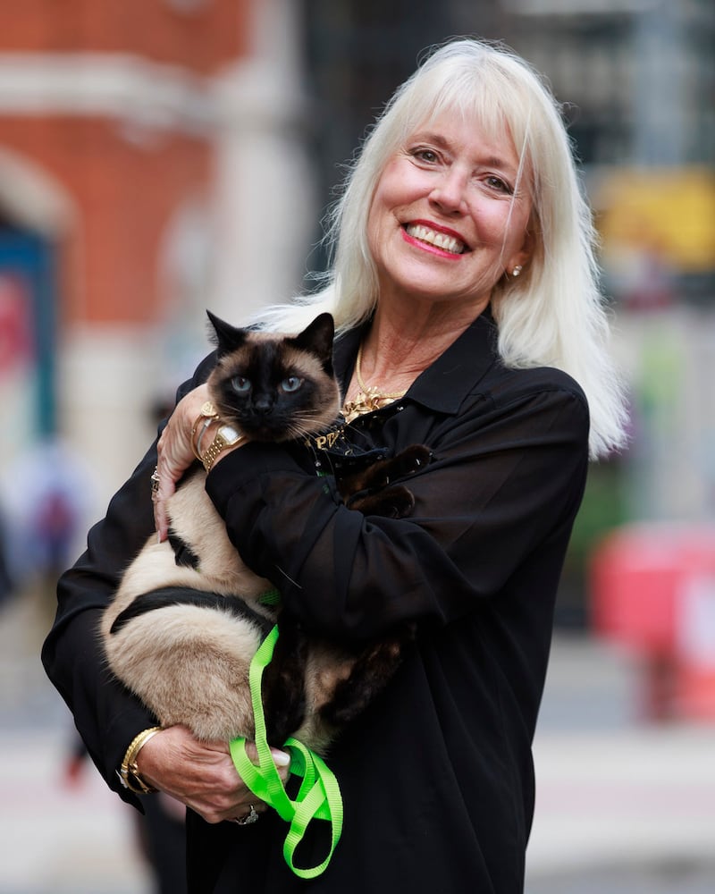 Holly Hennessy with her Siamese cat Captain at the Europa Hotel in Belfast